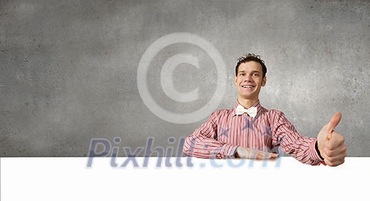 Young man in casual with white blank banner Young man in casual with white blank banner