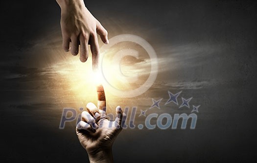 Close up of two hands reaching each other with fingers Close up of two hands reaching each other with fingers