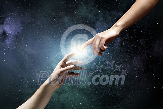 Close up of two hands reaching each other with fingers Close up of two hands reaching each other with fingers