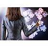 Rear view of businesswoman drawing puzzle elements