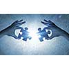 Close up image of hands connecting puzzle elements