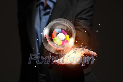 Close up of businesswoman holding bubble with graphs in hand Close up of businesswoman holding bubble with graphs in hand