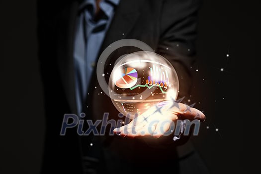 Close up of businesswoman holding bubble with graphs in hand Close up of businesswoman holding bubble with graphs in hand