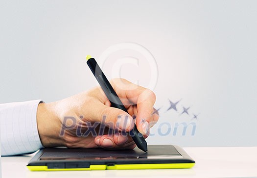 Close up of human hand using tablet for drawing Close up of human hand using tablet for drawing