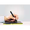 Close up of human hand using tablet for drawing