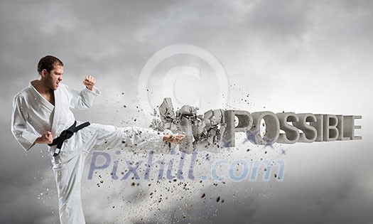 Young determined karate man breaking stone impossible word Young determined karate man breaking stone impossible word