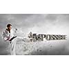 Young determined karate man breaking stone impossible word