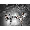Young determined karate man fighting with businessman in suit