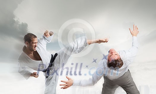 Young determined karate man fighting with businessman in suit Young determined karate man fighting with businessman in suit