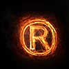 Glowing fire copyright sign on dark background
