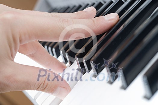 hand playing music on the piano hand playing music on the piano