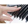 hand playing music on the piano