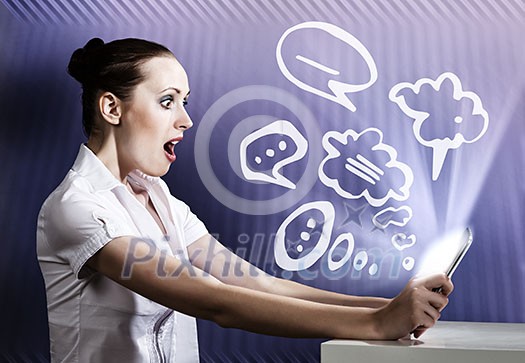 Young woman looking with surprise in tablet pc Young woman looking with surprise in tablet pc