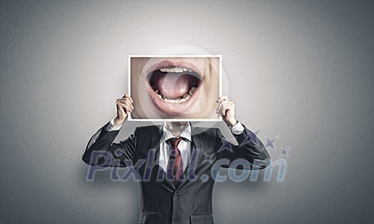 Businessman hiding head behind photo with huge mouth Businessman hiding head behind photo with huge mouth