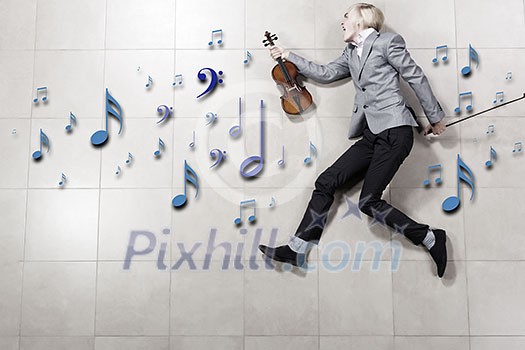 Young businessman running with violin in hand Young businessman running with violin in hand