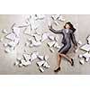 Attractive businesswoman running with papers in hand