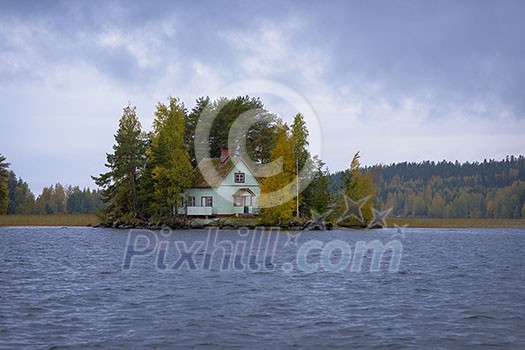 Little cottage on island in autumn Little cottage on island in autumn
