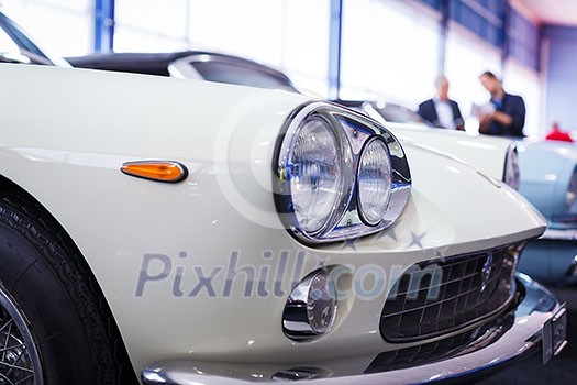 Old cars auction - People viewing cars on sale during an expensive old cars auction Old cars auction - People viewing cars on sale during an expensive old cars auction