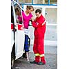 Paramedic taking care of a female patient - calling a hospital