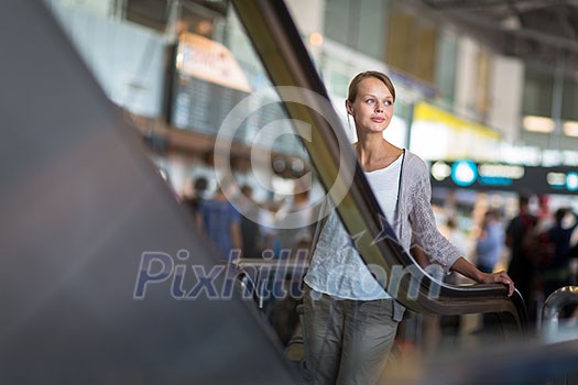 Young female passenger at the airport, about to check-in Young female passenger at the airport, about to check-in
