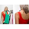 Young woman shopping in a fashion store - Trying on the garments she likes (color toned image; shallow DOF)