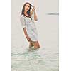 Woman relaxing at the beach with arms open enjoying her freedom,  independence, good health, time off.