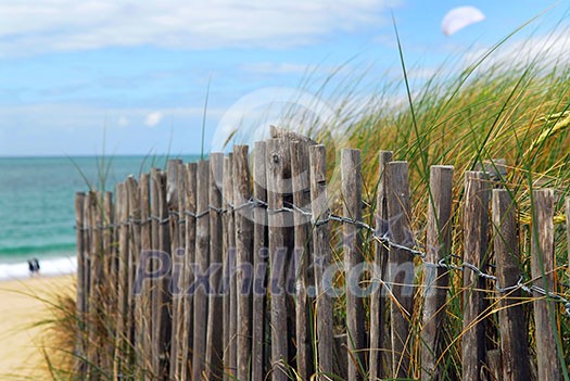 Old wooden fence on a beach in Brittany, France Old wooden fence on a beach in Brittany, France