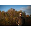Portrait of a senior man outdoors, walking in a park (shallow DOF; color toned image)