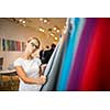 Pretty young woman  choosing the right material/color for her modern appartement interior (shallow DOF; color toned image)
