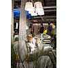 Pretty, young woman choosing the right furniture for her apartment in a modern home furnishings store (color toned image; shallow DOF)
