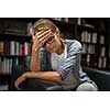 Woman suffering from depression Sitting in a chair (shallow DOF)