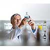 Senior male researcher carrying out scientific research in a lab (shallow DOF; color toned image)