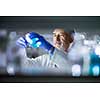 Senior male researcher carrying out scientific research in a lab (shallow DOF; color toned image)
