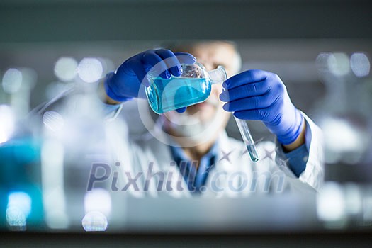 Senior male researcher carrying out scientific research in a lab (shallow DOF; color toned image) Senior male researcher carrying out scientific research in a lab (shallow DOF; color toned image)