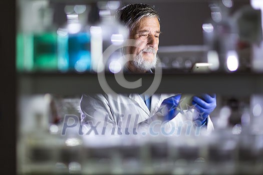 Senior male researcher carrying out scientific research in a lab (shallow DOF; color toned image) Senior male researcher carrying out scientific research in a lab (shallow DOF; color toned image)