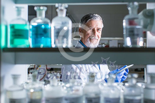 Senior male researcher carrying out scientific research in a lab (shallow DOF; color toned image) Senior male researcher carrying out scientific research in a lab (shallow DOF; color toned image)
