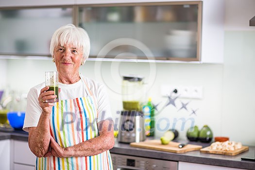 Senior woman cooking in the kitchen - eating and cooking healthy for her family; putting some potates in the oven, enjoying active retirement (shallow DOF; color toned image) Senior woman cooking in the kitchen - eating and cooking healthy for her family; putting some potates in the oven, enjoying active retirement (shallow DOF; color toned image)