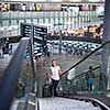 Young female passenger at the airport, using her tablet computer while waiting for her flight (color toned image)