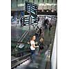 Young female passenger at the airport, transfering to her gate to board her flight on time(color toned image)
