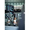 Young female passenger at the airport, transfering to her gate to board her flight on time(color toned image)