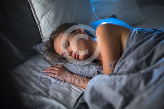 Beautiful young woman sleeping in bed (colour toned image; shallow DOF) Beautiful young woman sleeping in bed (colour toned image; shallow DOF)