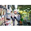Beautiful young woman shopping in a grocery store/supermarket on a cold winter day(color toned image)