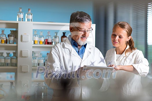 Senior chemistry professor/doctor in a lab (color toned image) Senior chemistry professor/doctor in a lab (color toned image)
