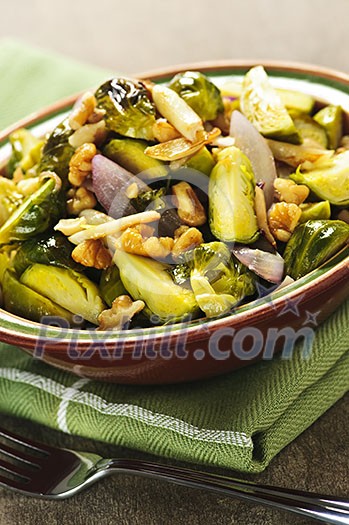 Vegetarian bowl of roasted brussels sprouts with walnuts Vegetarian bowl of roasted brussels sprouts with walnuts