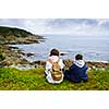 Children looking at coastal view of rocky Atlantic shore in Newfoundland, Canada