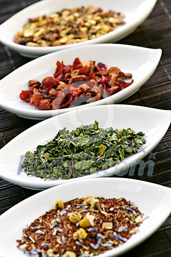 Herbal wellness dried tea in four bowls Herbal wellness dried tea in four bowls