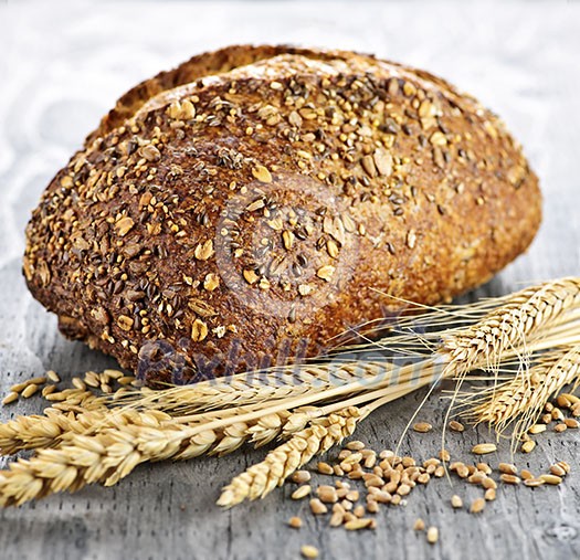 Loaf of fresh baked multigrain bread with grain ears Loaf of fresh baked multigrain bread with grain ears