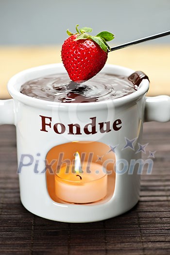 Strawberry dipped in delicious melted chocolate fondue Strawberry dipped in delicious melted chocolate fondue