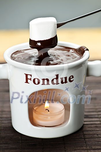 Marshmallow dipped in delicious melted chocolate fondue Marshmallow dipped in delicious melted chocolate fondue