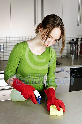 Girl cleaning kitchen with sponge and rubber gloves Girl cleaning kitchen with sponge and rubber gloves